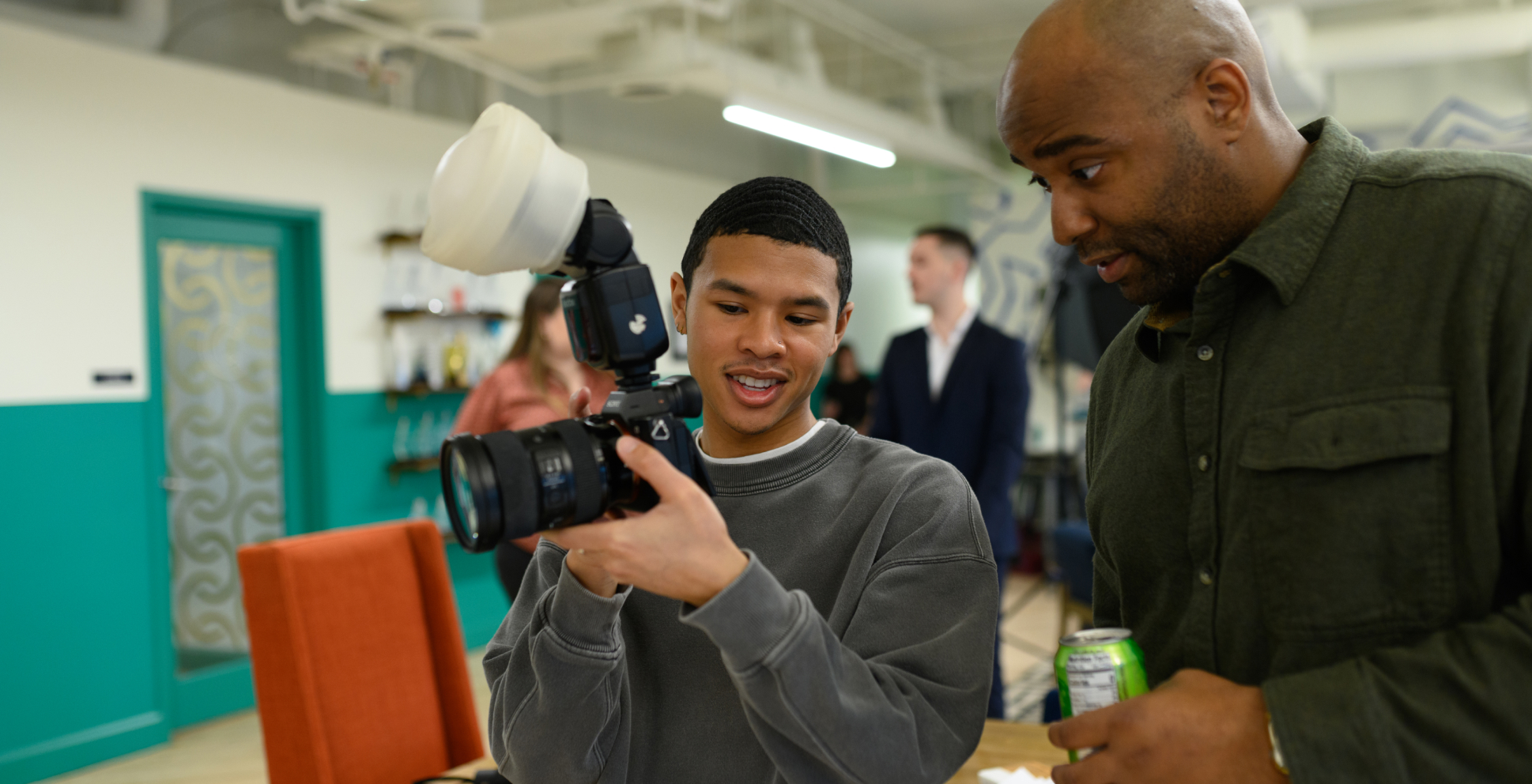 Three team members viewing a video